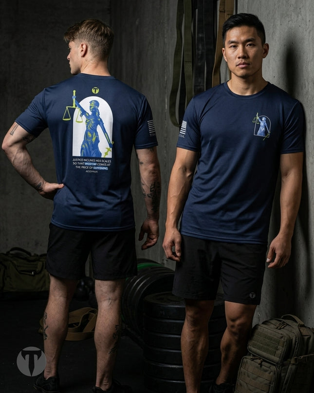 Two male models wearing Titan 6 Endure T-shirt in the Lady Justice design in a gym setting, showing the front and back views. The back of the shirt features a large graphic of the Lady Justice holding a scale of justice.