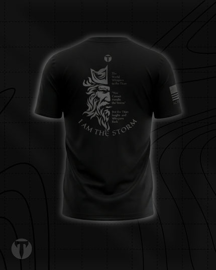 Back view of the Titan 6 Men's Endure T-Shirt in black, featuring a light grey split graphic of a bearded Titan's face alongside text reading "The World Whispers to the Titan, 'You Cannot Handle the Storm,' But the Titan laughs and Whispers Back: I AM THE STORM."