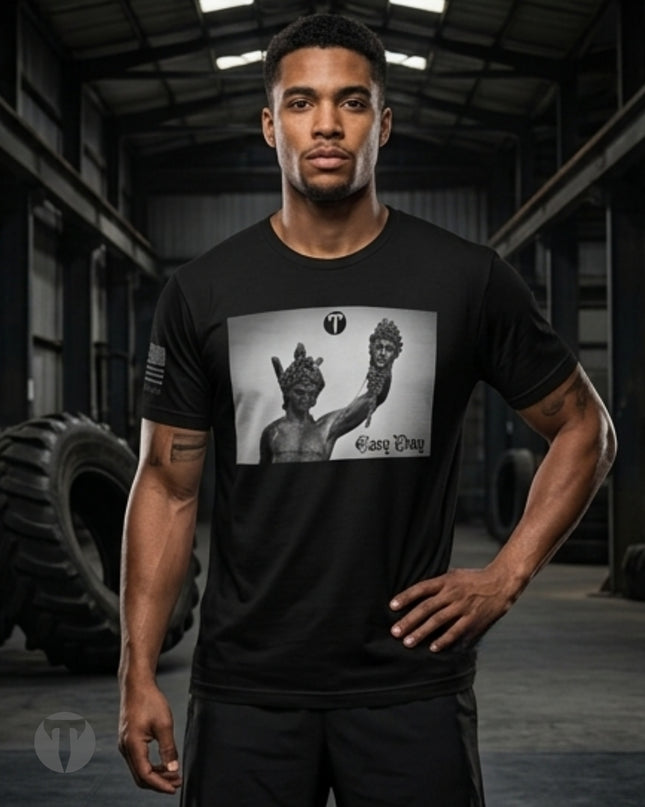 Front view of the Titan 6 Men's Endure T-Shirt in black, featuring a boxed chest graphic of the Perseus holding the head of Medusa statue alongside the text "Easy Day", a Titan 6 logo, and an American flag printed on the right sleeve.