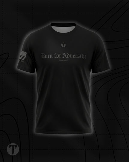 Front view of the Titan 6 Men's Endure T-Shirt in black, featuring the dark grey Gothic chest graphic "Born for Adversity" with "Proverbs 17:17" below it, a small Titan 6 Icon logo, and an American flag on the right sleeve.