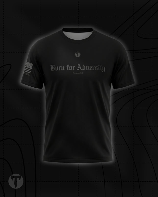 Front view of the Titan 6 Men's Endure T-Shirt in black, featuring the dark grey Gothic chest graphic "Born for Adversity" with "Proverbs 17:17" below it, a small Titan 6 Icon logo, and an American flag on the right sleeve.