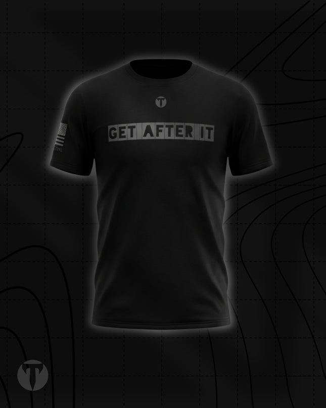 Front view of the Titan 6 Men's Endure T-Shirt in black, featuring the grey block-letter chest graphic "GET AFTER IT" below a small Titan 6 Icon logo and a monochromatic American flag printed on the right sleeve.