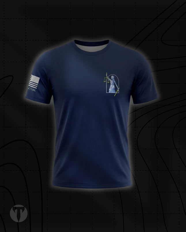 Front view of the Titan 6 Men's Endure T-Shirt in navy blue, featuring a small Lady Justice graphic holding scales and a sword on the left chest, with a white American flag printed on the right sleeve.