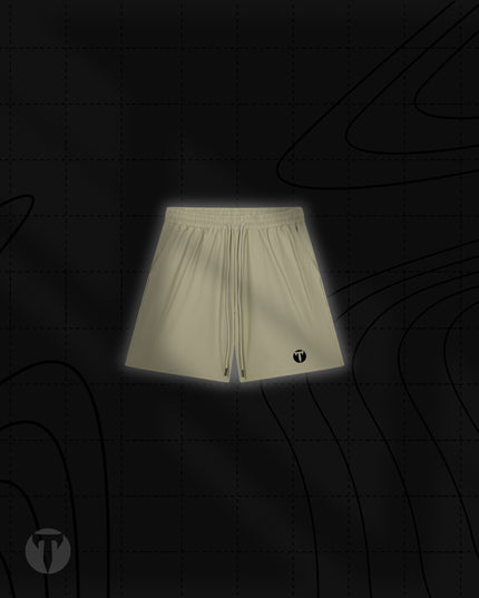 Front view of the Titan 6 Men's Stamina Drawstring Linerless Shorts in khaki, featuring an elastic waistband with drawstrings and the dark Titan 6 Icon logo printed on the left leg hem.