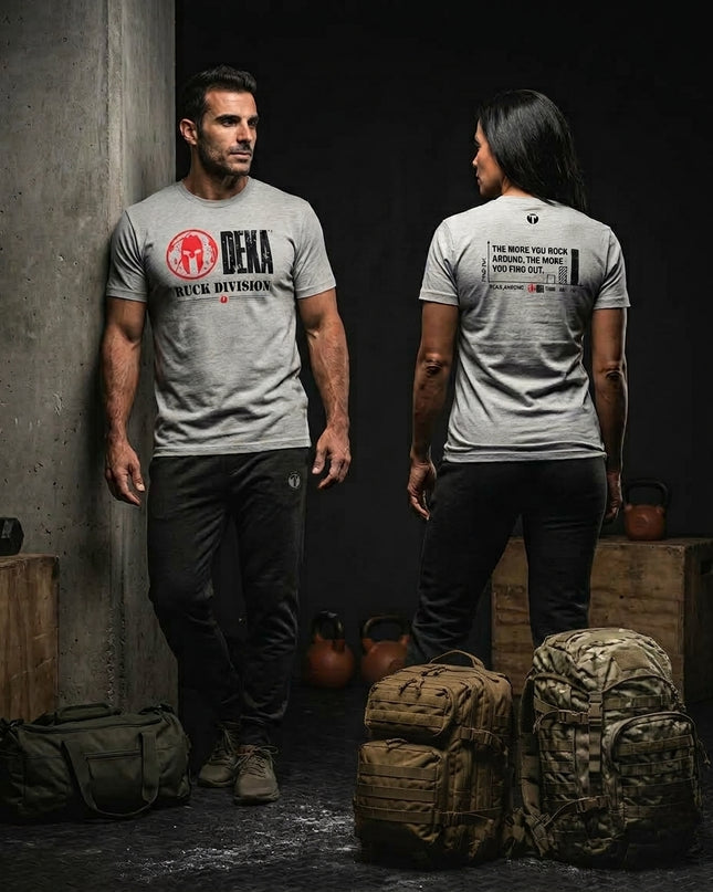 Male and female athletes wearing gray Spartan DEKA Ruck Division graphic t-shirts alongside tactical rucksacks and kettlebells in a training facility.