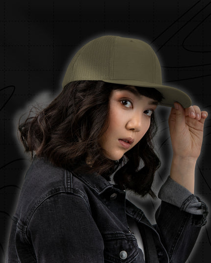 Woman wearing a black stonewash denim jacket and the Titan 6 Richardson 112 Trucker Snapback Cap in olive green, featuring a silver Titan 6 Elite logo embroidered on the front left panel not seen from this angle.