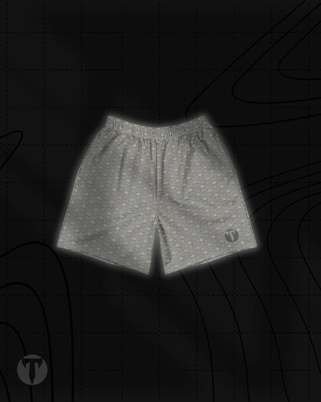Front view of the Titan 6 Unisex Endure 6-Inch Linerless Shorts in Dragon's Den, featuring a light grey repeating skull and dragon graphic pattern with a dark Titan 6 Icon logo on the left leg hem.