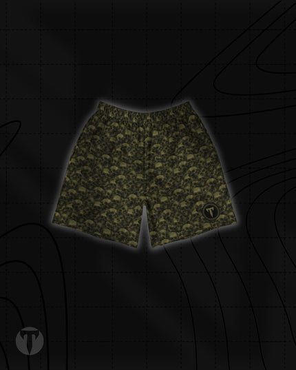 Front view of the Titan 6 Unisex Endure 6-Inch Linerless Shorts in Golgotha, featuring an olive green and black repeating skull pattern with a round Titan 6 logo on the left leg hem.