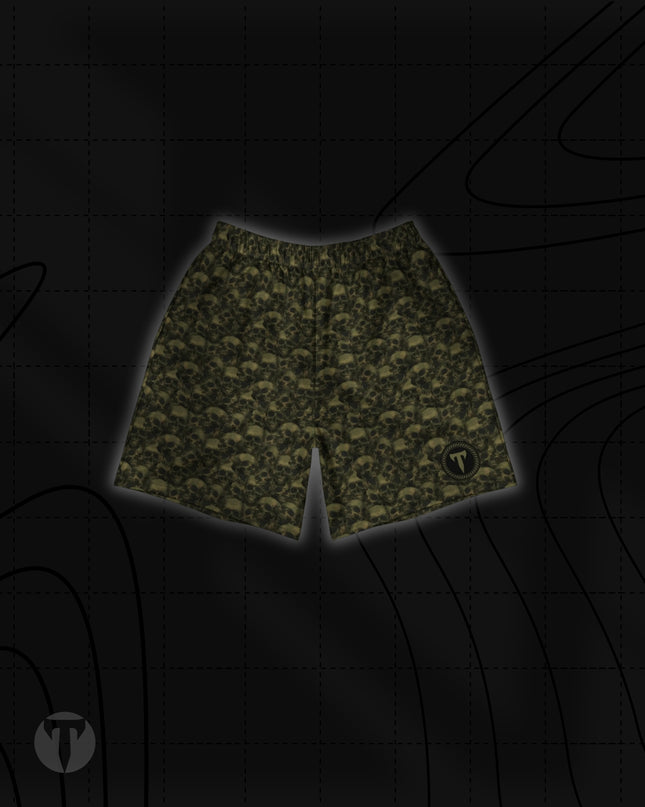 Front view of the Titan 6 Unisex Endure 6-Inch Linerless Shorts in Golgotha, featuring an olive green and black repeating skull pattern with a round Titan 6 logo on the left leg hem.