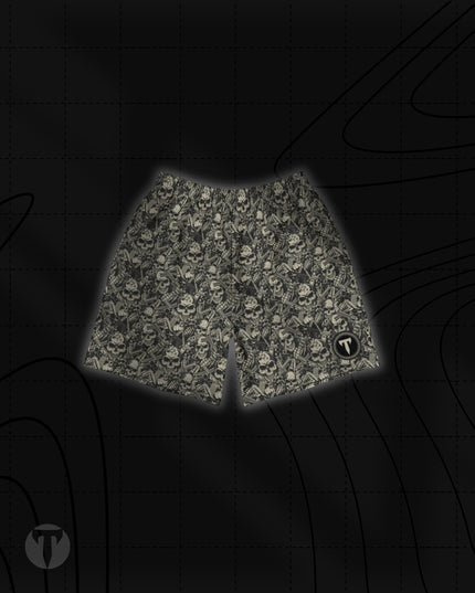 Front view of the Titan 6 Unisex Endure 6-Inch Linerless Shorts featuring a monochrome Outlaw skull and weapon pattern with the dark Elite logo on the left leg hem.