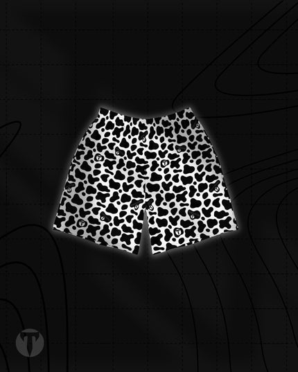 Front view of the Titan 6 Unisex Endure 6-Inch Linerless Shorts featuring the black and white Udder Chaos cow print pattern with small embedded Titan 6 logos throughout.