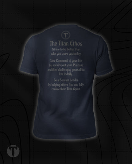 Back view of the Titan 6 Unisex Nomad Tee in Heather Navy, featuring "The Titan Ethos" printed across the back beneath a circular "T" logo, detailed with three core principles for growth, purpose, and servant leadership.