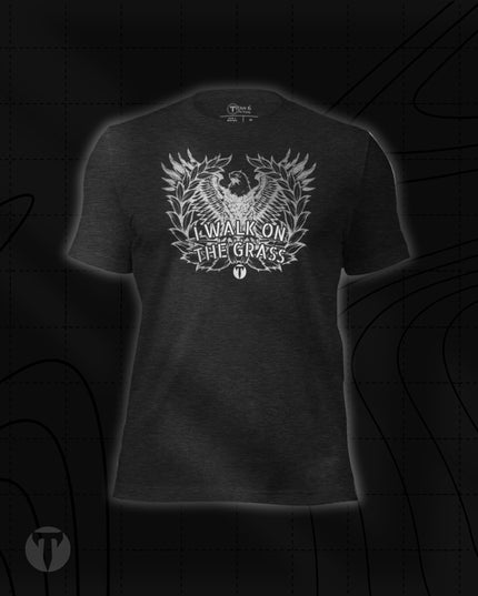 Titan 6 Unisex Nomad Tee in Dark Grey Heather, featuring an eagle emblem framed by a laurel wreath with "I WALK ON THE GRASS" printed across the front.