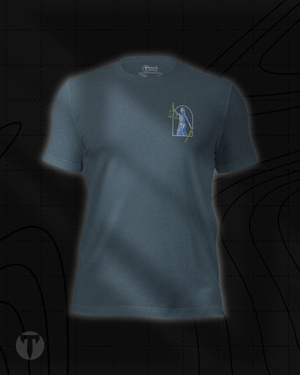 Titan 6 Unisex Nomad Tee in Heather Slate, featuring a small Lady Justice figure inside an arched frame printed on the left chest with green highlights on her scales and sword.