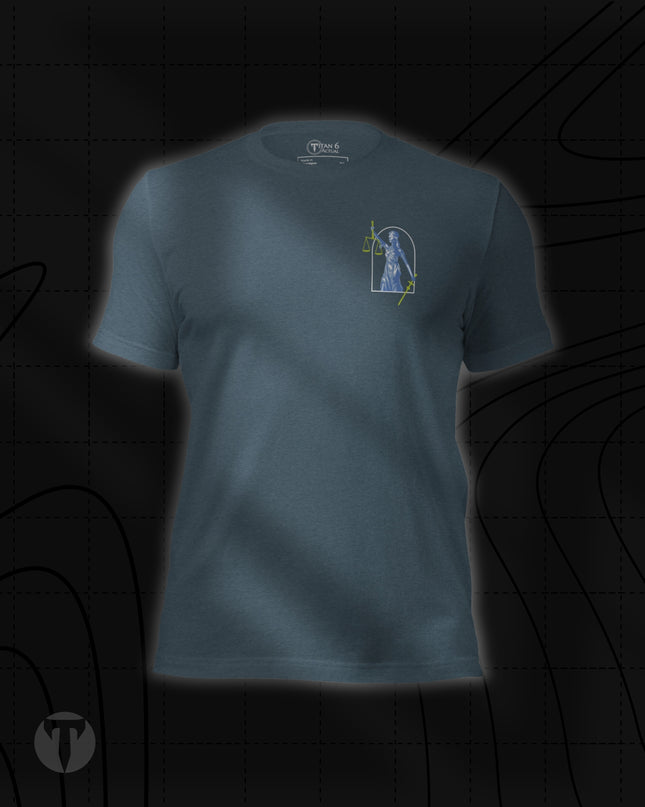 Titan 6 Unisex Nomad Tee in Heather Slate, featuring a small Lady Justice figure inside an arched frame printed on the left chest with green highlights on her scales and sword.