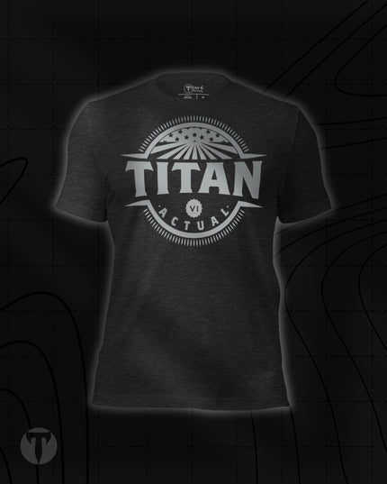 Titan 6 Unisex Nomad Tee in Dark Grey Heather, featuring a retro circular "TITAN 6 ACTUAL" emblem centered on the chest with stars and rays design.