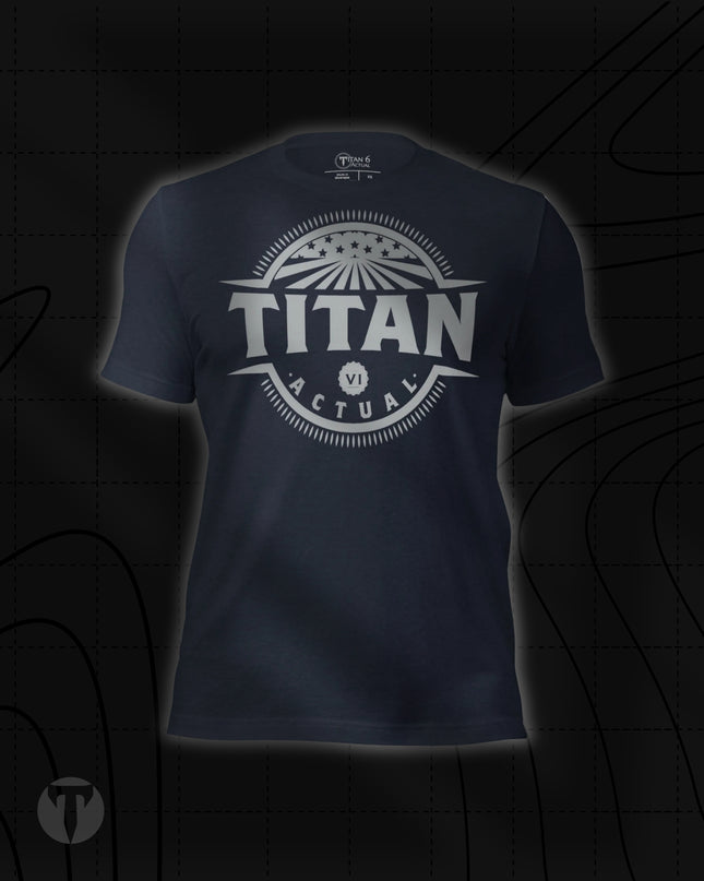 Titan 6 Unisex Nomad Tee in Heather Navy, featuring a retro circular "TITAN 6 ACTUAL" emblem centered on the chest with stars and rays design.