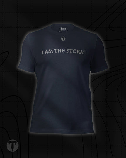 Titan 6 Unisex Nomad Tee in Heather Navy, featuring "I AM THE STORM" printed across the upper chest in a stylized font, with a small "T" logo centered above it.