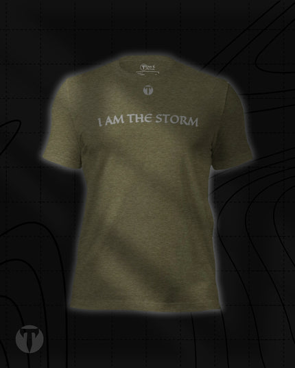 Titan 6 Unisex Nomad Tee in Heather Olive, featuring "I AM THE STORM" printed across the upper chest in a stylized font, with a small "T" logo above it.