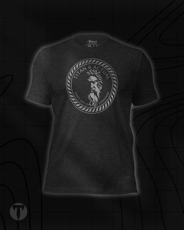 Titan 6 Unisex Nomad Tee in Dark Grey Heather, featuring a circular silver Zeus emblem centered on the chest.
