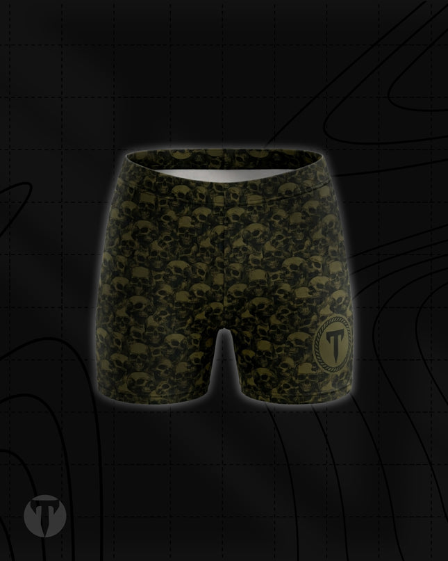Titan 6 Women's Glide Shorts in Golgotha, featuring an all-over olive drab green and black skull pattern with a circular "T" logo on the lower left leg.