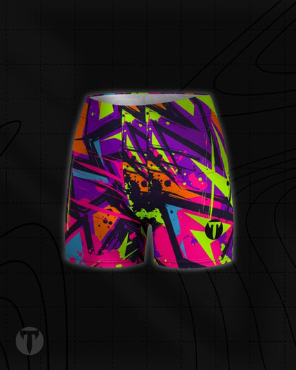 Titan 6 Women's Glide Shorts in Zack Wiz, featuring a vibrant 90s-style abstract graffiti print in neon pink, lime green, orange, purple, and blue, with a black circular "T" logo on the lower left leg.