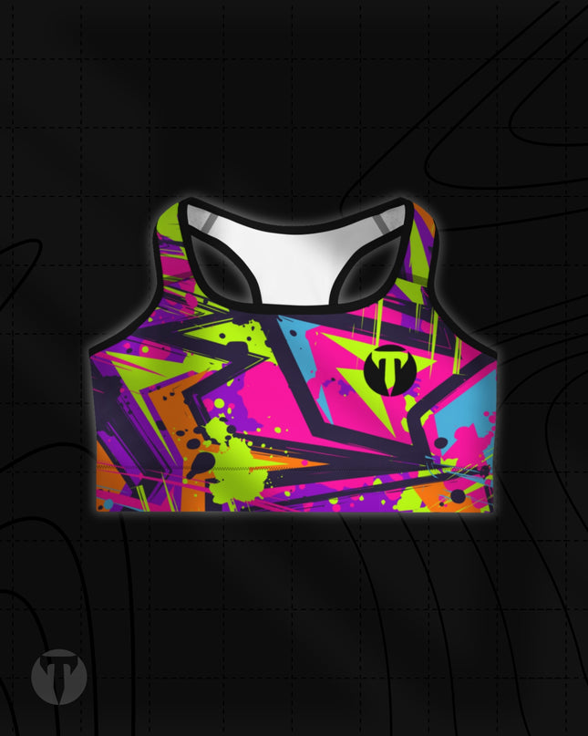 Titan 6 Women's Glide Sports Bra featuring a vibrant 90s-style abstract graffiti print in neon pink, lime green, purple, and blue, with a black "T" logo on the left chest.