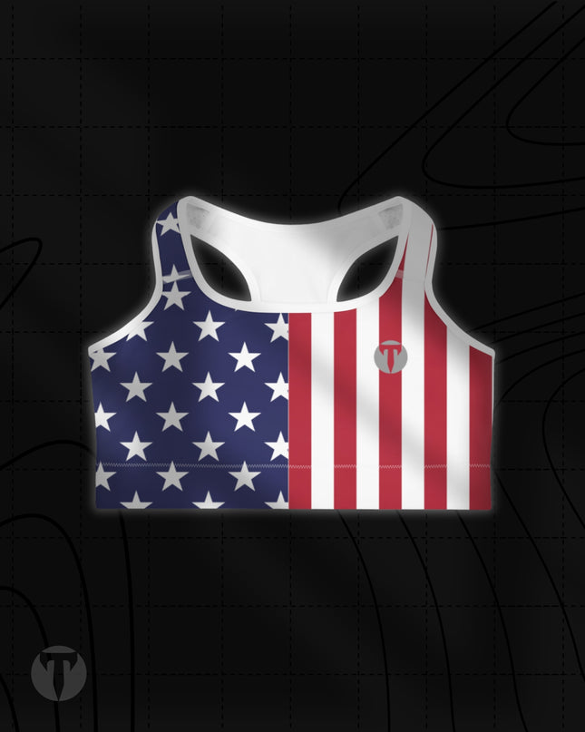 Titan 6 Women's Glide Sports Bra in Old Glory, featuring a split American flag print with white stars on blue on the right and red and white vertical stripes on the left with a grey "T" logo.