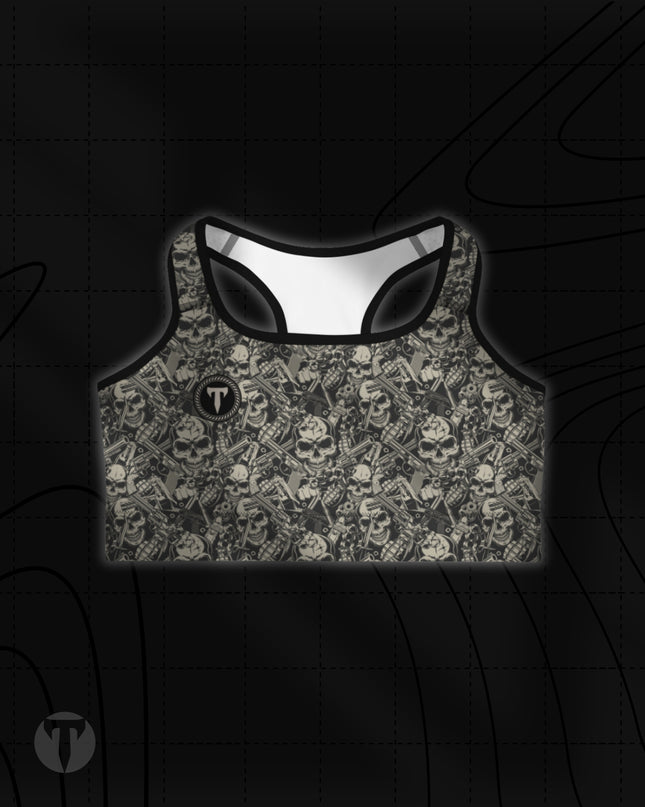 Titan 6 Women's Glide Sports Bra in Outlaw print, featuring an all-over dark grey and tan pattern of skulls, revolvers, and grenades with a small black "T" logo on the right chest.